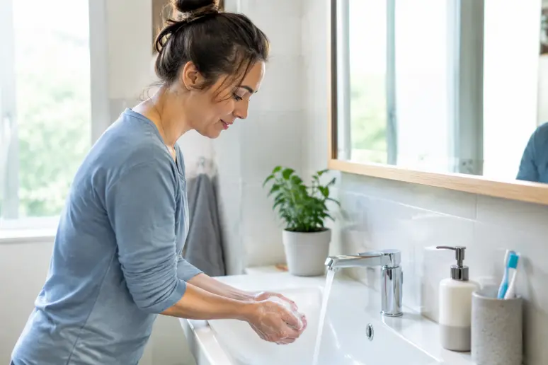 Personne se lavant soigneusement les mains pour respecter les consignes d'hygiène post-opératoire